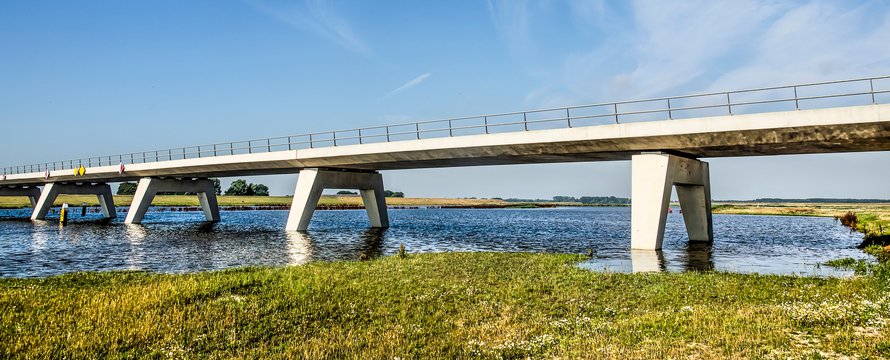 Kampen, The Netherlands, July 29, 2019: new concrete bridge across the Reevediep flood channel of the IJssel river under a blue sky on a summer morning
