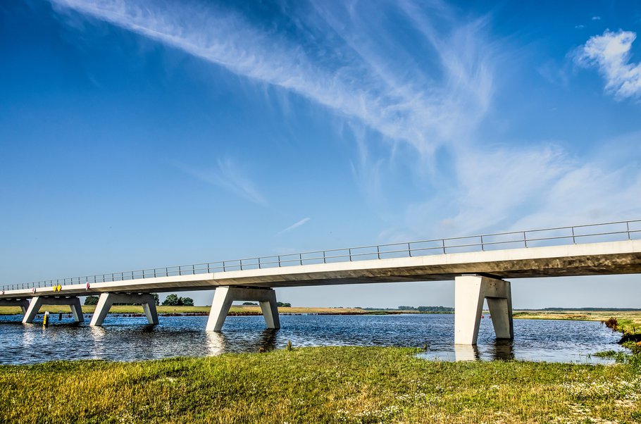 Kampen, The Netherlands, July 29, 2019: new concrete bridge across the Reevediep flood channel of the IJssel river under a blue sky on a summer morning