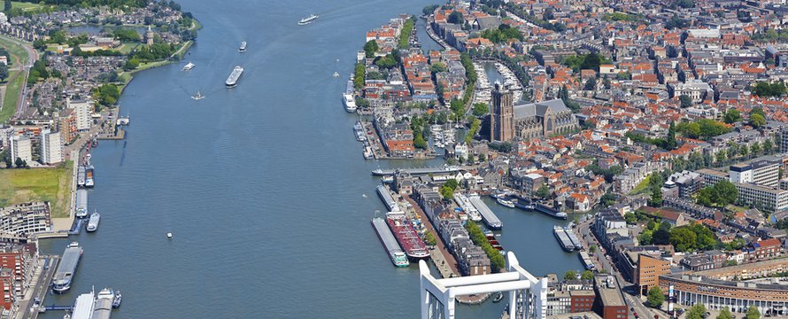 Aerial view of the city Dordrecht with the 'Grote Kerk' (Great Church) which had its origin in 1285, first catholic, later protestant. The tower was never finished. Flag of Dordrecht. The Netherlands