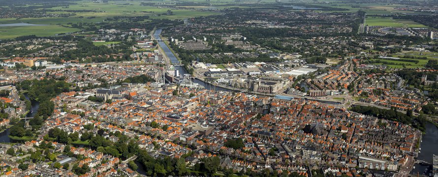 Aerial view of the city of Alkmaar. On the clear horizon a blue sky with cumulus clouds. Alkmaar is an old town in NOORD-HOLLAND, The Netherlands and known for it's KAASMARKT or cheese market.